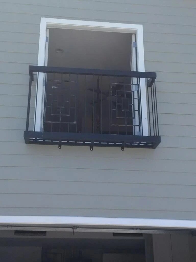 Sunlit iron balcony overlooking the city