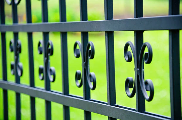 Classic iron fence along a sidewalk 